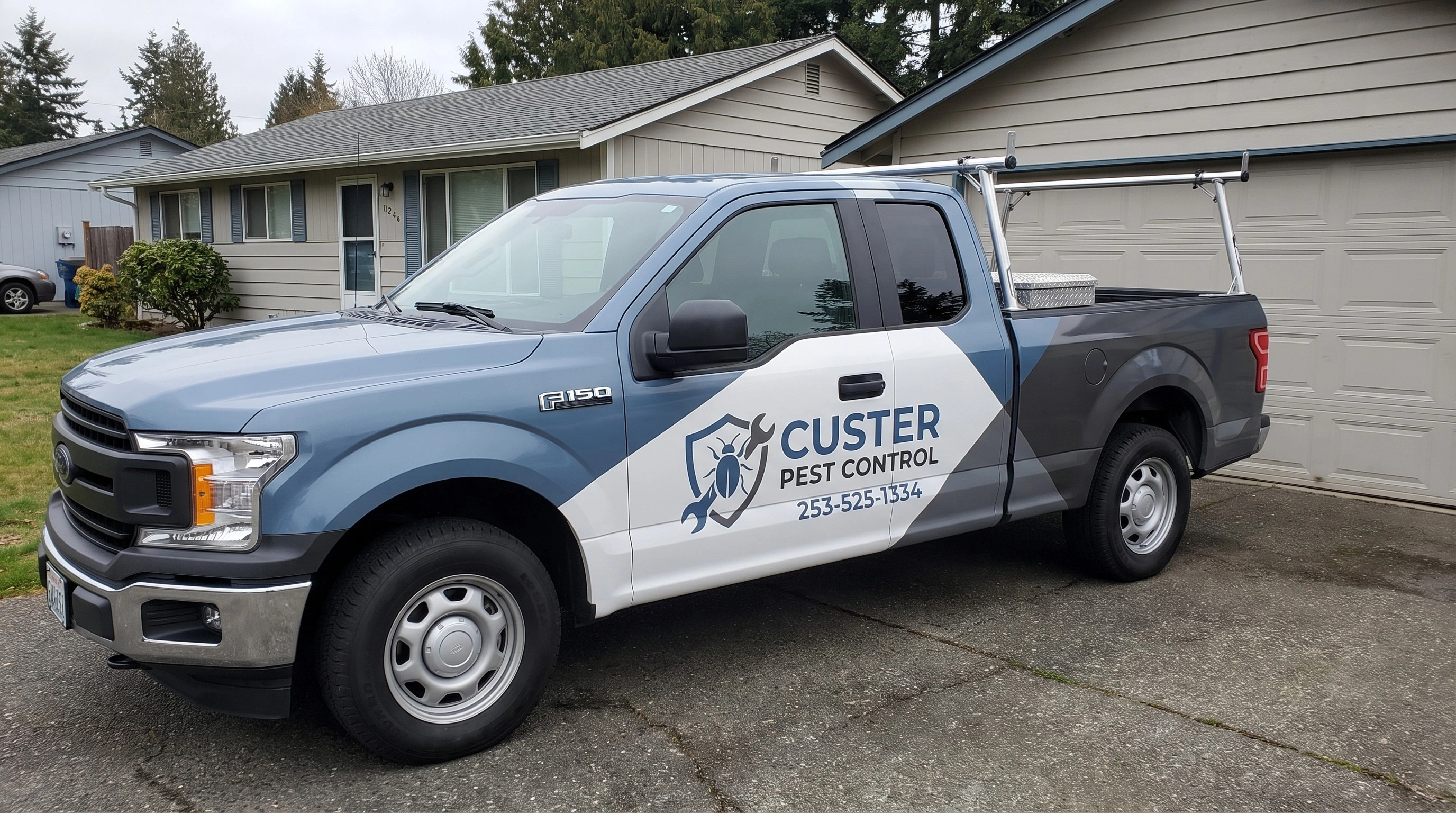 Custer Pest Control technician treating a Tacoma home for pests